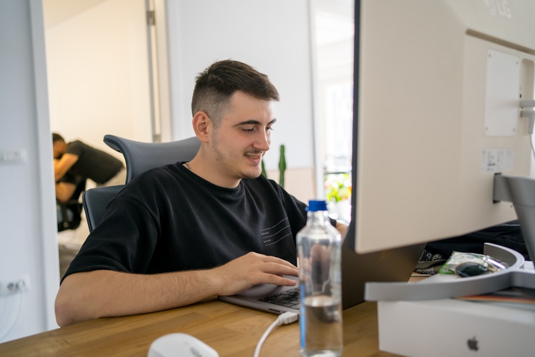 Man working at a desk, exploring the key benefits of online fax services for modern businesses.